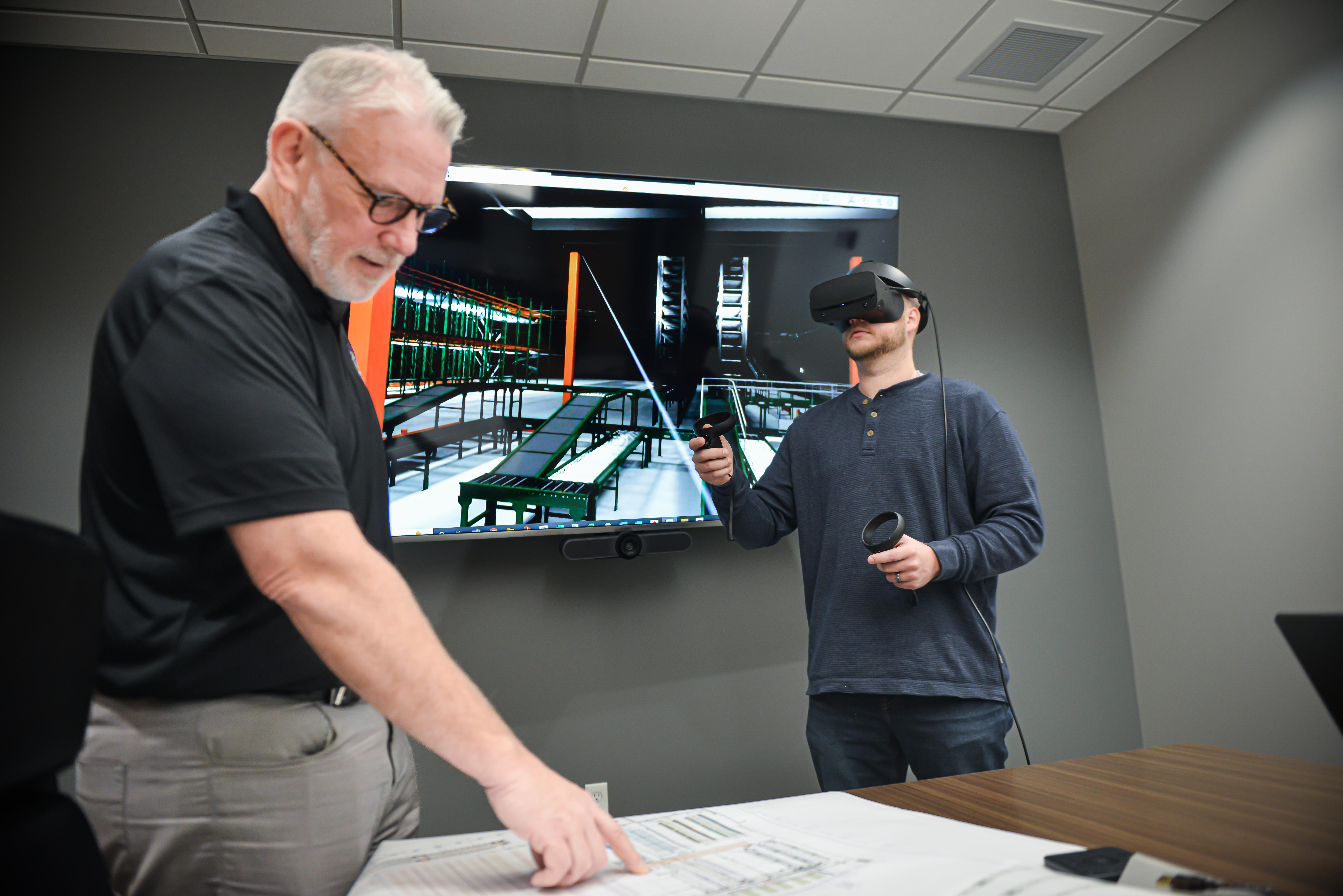 VR - Mark explaining to Alex who is wearing VR goggles